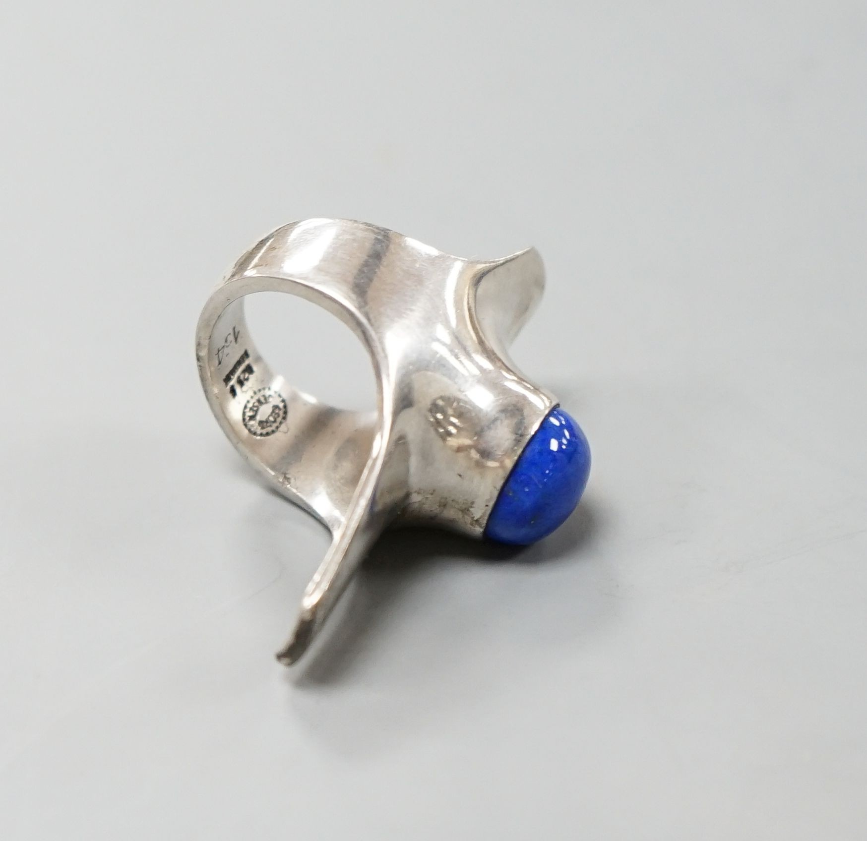 A Georg Jensen sterling and lapis lazuli set upfinger ring, no. 154, size K/L.